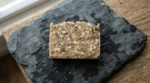 Nourishing goat milk soap bar infused with oats on a slate tile background